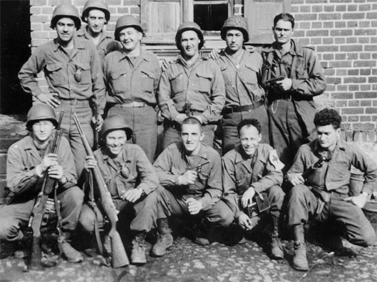 Photograph showing Pvt Richard T. Wright (kneeling, second from left) of the 48th Field Hospital, who later transferred to the 35th Infantry Division, where he served as a Browning Automatic Rifle Assistant Gunner.Photograph, courtesy of Donald L. Wright.