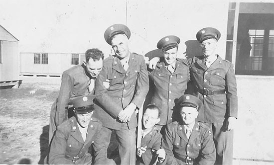 A group of unidentified Enlisted Men of the 30th Evacuation Hospital pose for the camera in front of their barracks building at Camp Barkeley, Texas. Photograph taken during the early phases of the unit's training program in the Zone of Interior. 