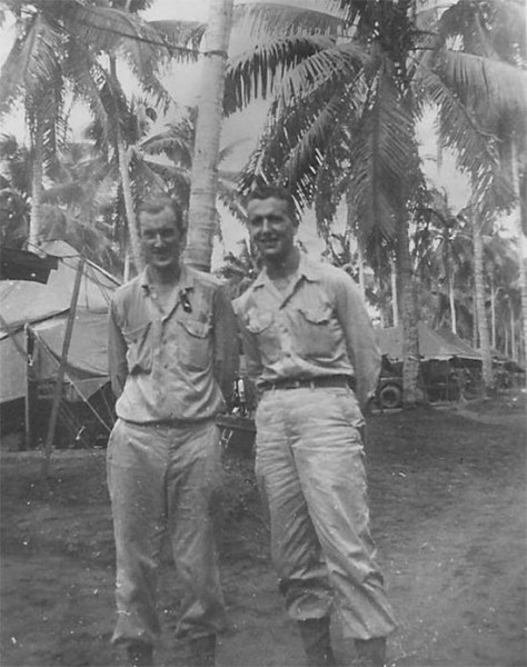 Two unidentified members of the 30th Evac Hosp pictured in front of the unit's tentage on the Philippines. 