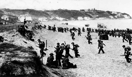 Members of the 1st Infantry Division storm the beach at Arzew, French Morocco, on 8 November 1942.