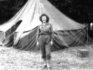 Photo of 1st Lieutenant Ruth M. Haddick, serving with the 2d Hospitalization Unit, 51st Field Hospital in front of a M-1934 Pyramidal Tent.