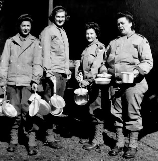 Picture illustrating four Nurses of the 107th Evacuation Hospital. Taken in the Zone of Interior, the ANC Officers are still wearing the SSI of the Second United States Army. Time for chow?