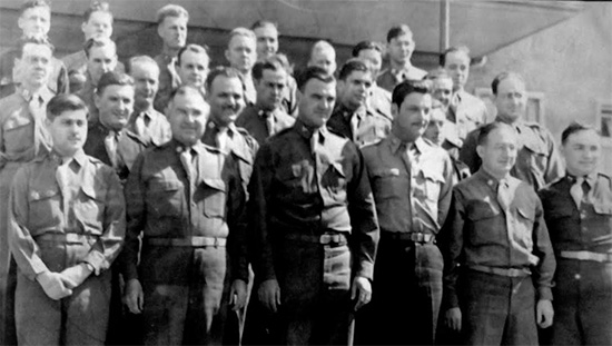 Picture illustrating Officers of the 107th Evacuation Hospital standing around their CO, Colonel H. W. Daine. Most probably taken around the end of the war in Würzburg, Germany.