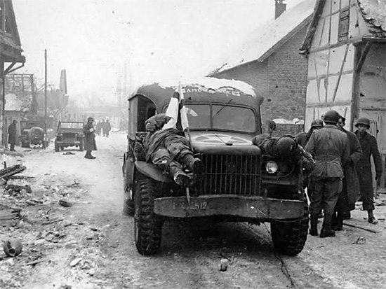 Winter scene. Recovered bodies of dead enemy soldiers are evacuated to the rear in American WC-54 3/4-ton ambulances. Photo taken 26 January 1945 in Germany.