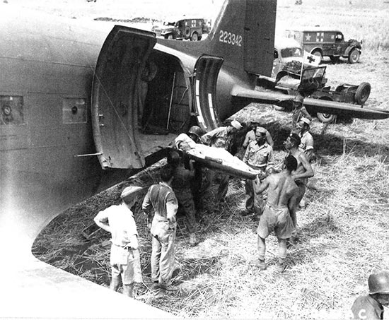 Another vintage photo illustrating a litter patient being carried aboard one of the C-47 aircraft, prior to his evacuation for further treatment in North Africa. Photo also taken at Agrigento, Sicily, 25 July 1943. The 802d MAETS was soon called in to provide medical attendants to accompany the casualties during flight. 