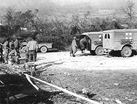 Vintage photo illustrating patients coming in by 3/4-ton ambulance. Photo taken in the vicinity of Venafro, Italy, February 1944, where Unit I, 11th Field Hospital, was set up.