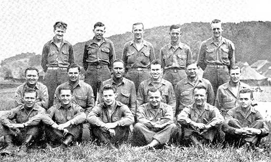 Photograph illustrating Enlisted Men of the 34th Evacuation Hospital Operating Section. Third Row, from L to R: John H. Hirtle; Willis E. Delker; George Lansdale; Harley  M. Johnson; John G. Coffland. Second Row, from L to R: Mirko Magulac; Eugene R. Fisher; Ira J. Glockner; Phillip K. Honeycutt; Mark M. Peterson; William H. Bass. First Row, from L to R: William W. Watford; Kash C. Williams; Frank L. Everly; Stephen M. Velkoff, Herbert Gold; Roy A. Wright. 