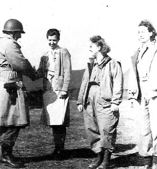 February 21, 1944, picture illustrating the award ceremony during which Major General John P. Lucas, CG, VI Corps, awarded 3 Silver Stars to Nurses, with the first citation honoring a 56th Evacuation Hospital ANC Officer, First Lieutenant Mary L. Roberts, ANC (pictured on the left).