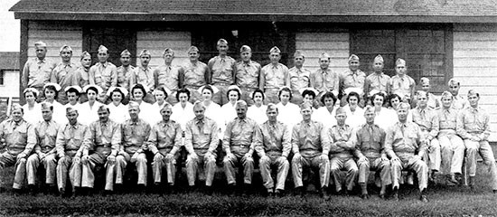 July 1942. Group picture illustrating Officers and Nurses of the 56th Evacuation Hospital prior to departure for the 1942 Louisiana Maneuvers. On July 23, 1942, the organization received its marching orders for Mansfield, Louisiana, from where they moved on to Fort Jessup, Louisiana (a deserted CCC camp), in order to set up a hospital in the area. The men were back at Fort Sam Houston, by 11 November 1942. 