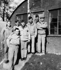 Group picture illustrating Quentin C. Unruh and friends in front of their Quonset hut, Stowell Park, England. Front row: Quentin C. Unruh; back row, from L to R: Holland C. Swallow, Paul E. Jones, unknown, James H. Day, Jesse Pitts, and Thomas J. Pollock. 