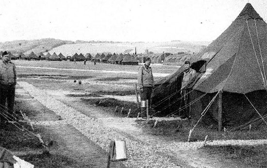 Partial view of endless rows of Quonset huts and canvas pyramidal tents at Parkhouse B, Salisbury Plain Training Area, Wiltshire, England. Picture taken during the latter part of July 1944, prior to the 58th General Hospital’s departure to its final marshalling and staging area for further movement to France and the continent.
