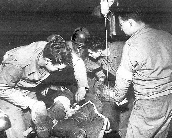 Treating the wounded on Anzio Beachhead, 56th Evacuation Hospital personnel are taking care of a patient.